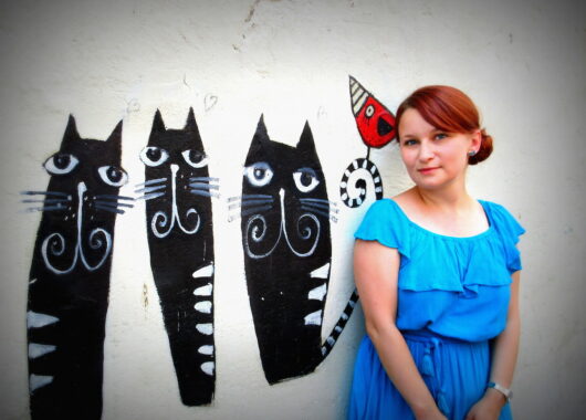Picture of StoryPlanet writer Anette John with cat grafitti